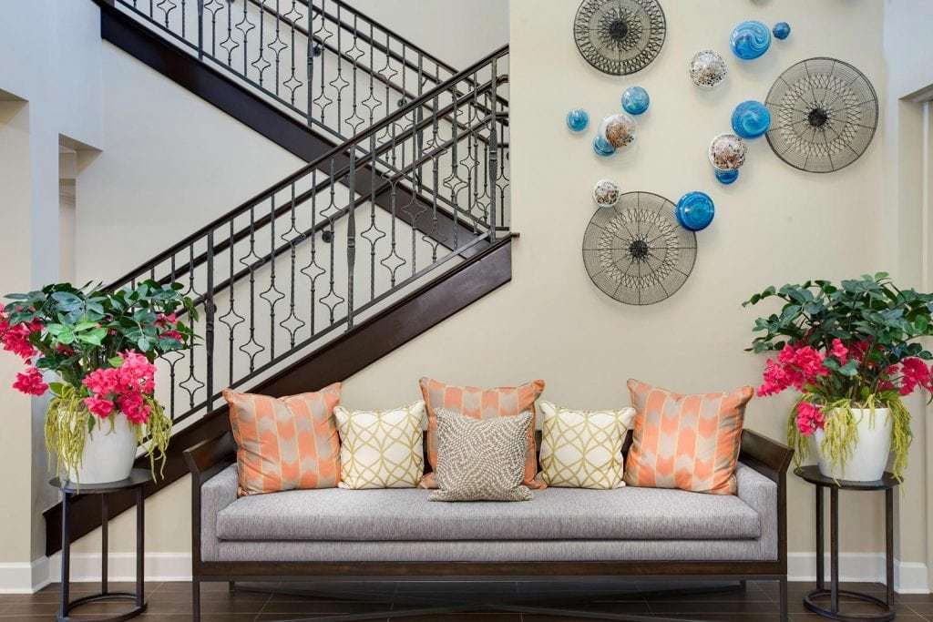 Front entrance seating area with art on the wall, and a staircase