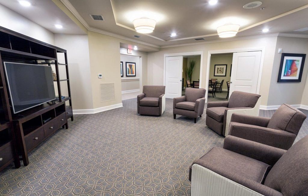 Movie viewing room with large TV and multiple reclining chairs