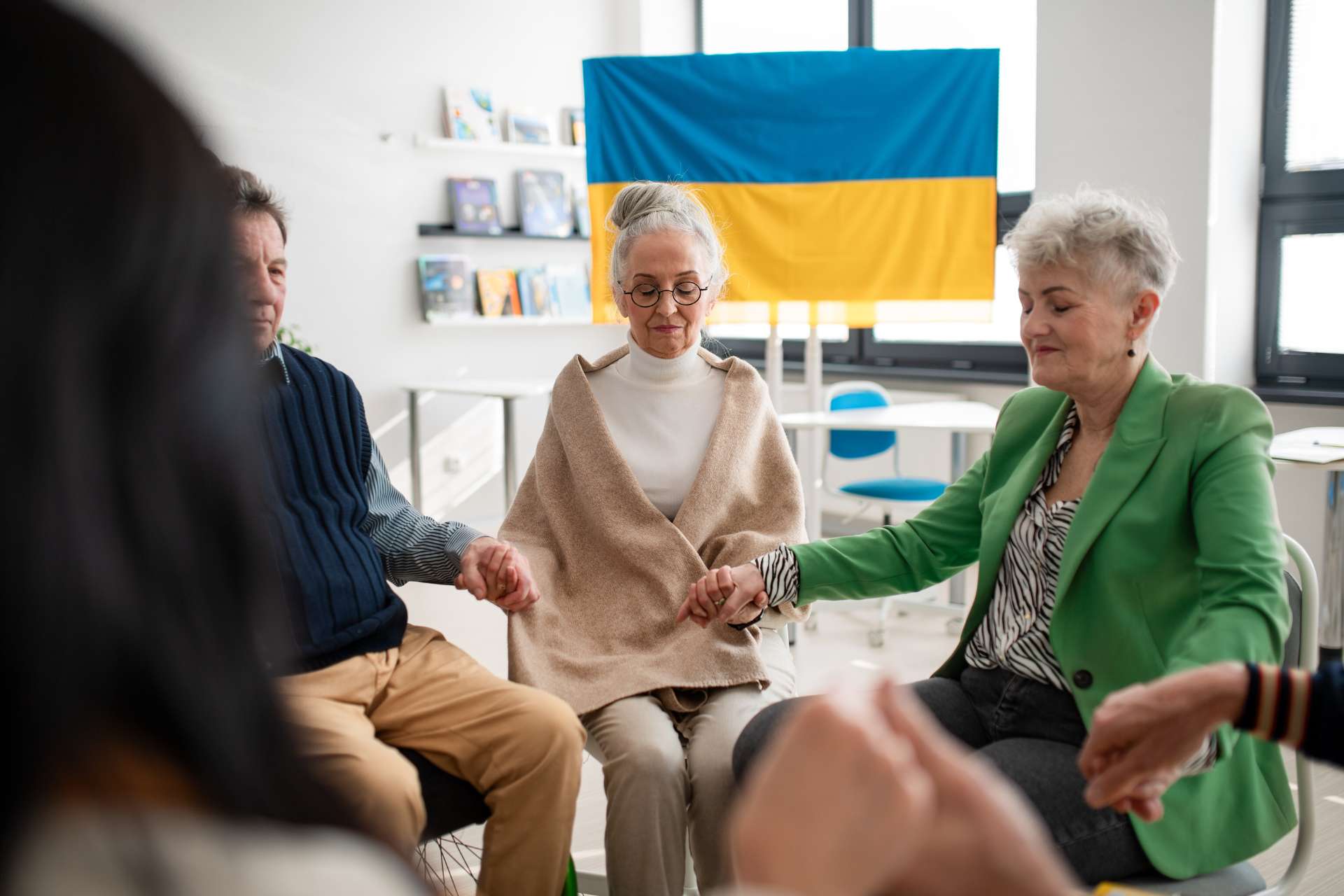 a group of seniors holding hands