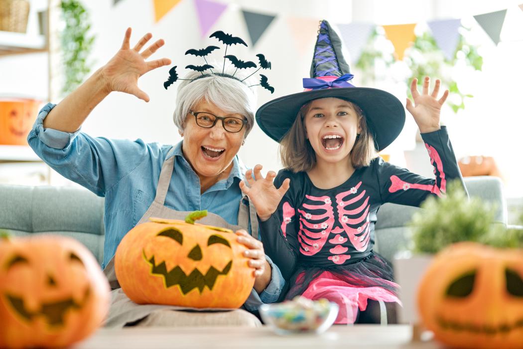 A grandmother and her granddaughter enjoying Halloween festivities.