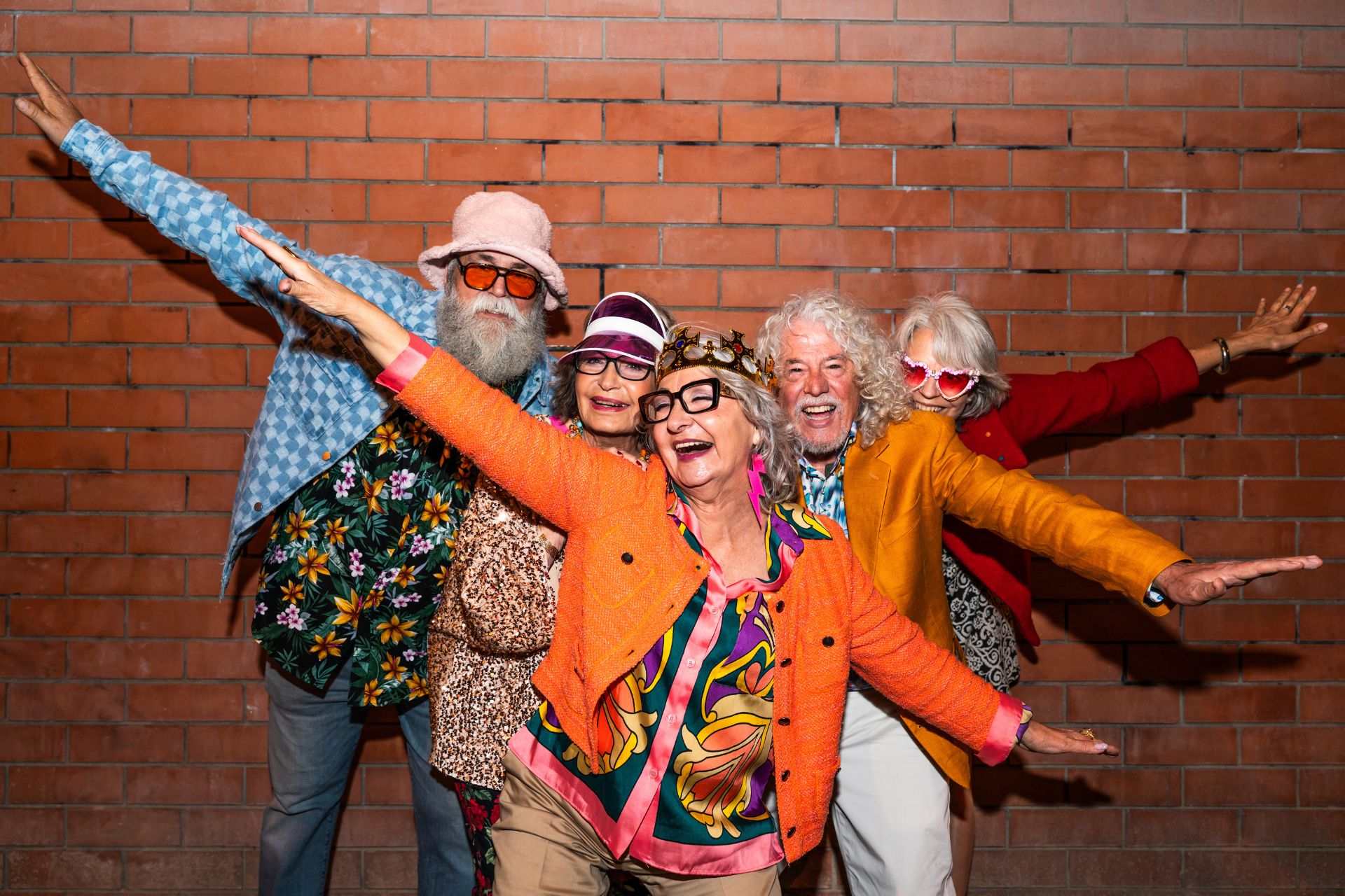 A group of happy senior friends wearing fancy clothing.
