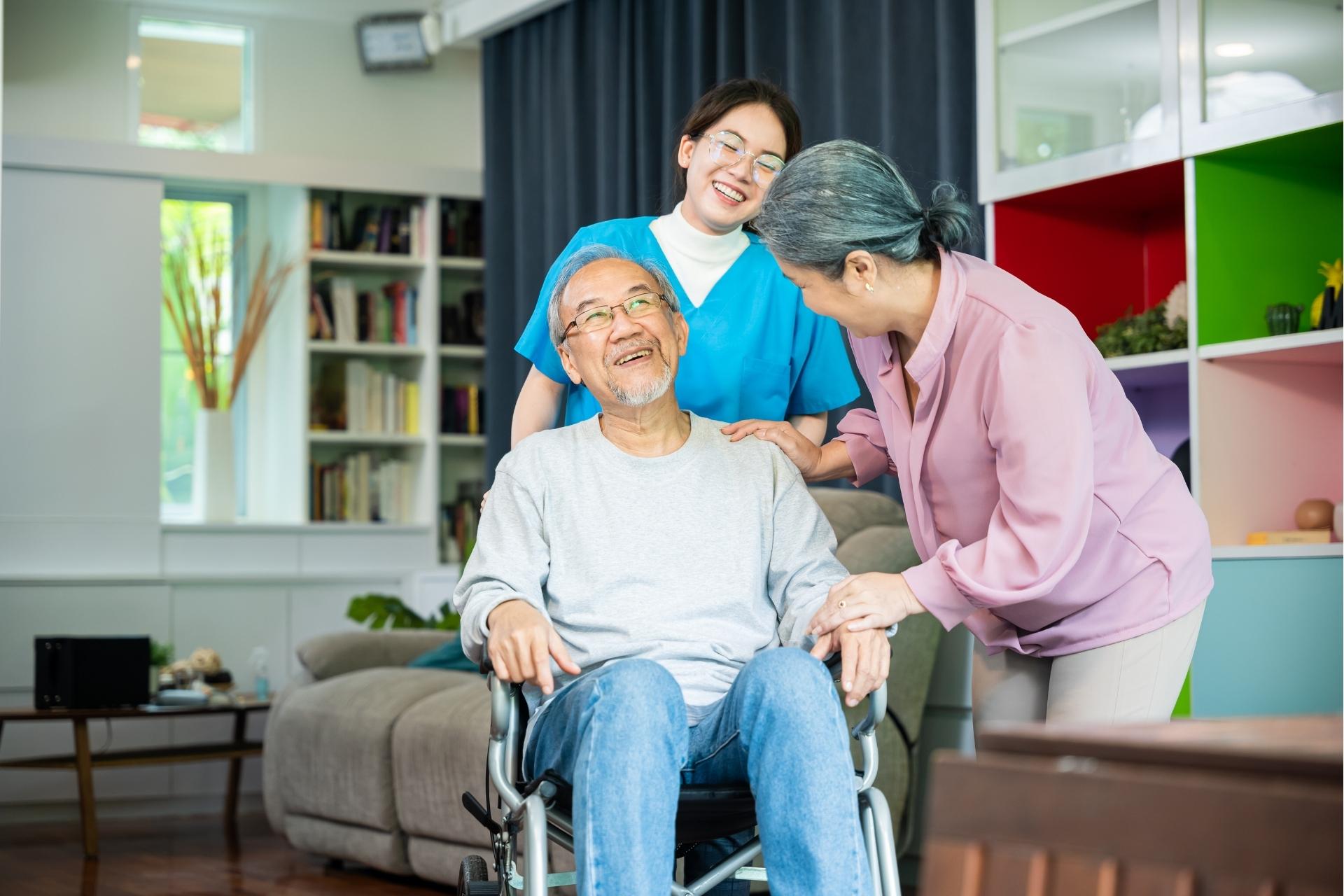 SafelyYou A senior couple with their caregiver, smiling.